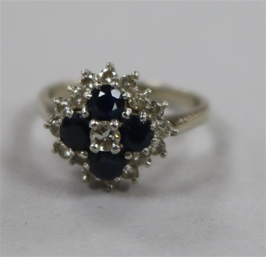 An 18ct white gold, sapphire and diamond cluster dress ring, size N.